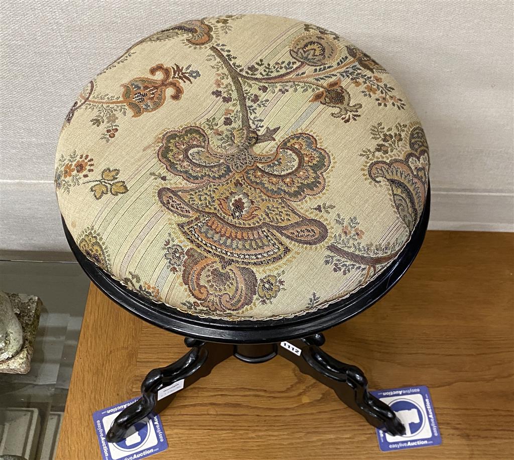 A 19th century French ebonised revolving adjustable piano stool